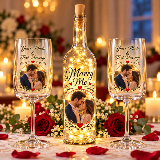 Clear wine bottle with a set of crystal wine glasses that have a photo and Marry Me on it.