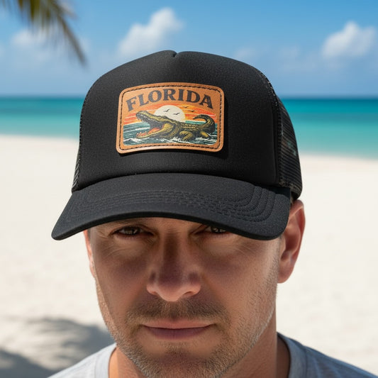 Man wearing a black cap with a Florida patch on a beach