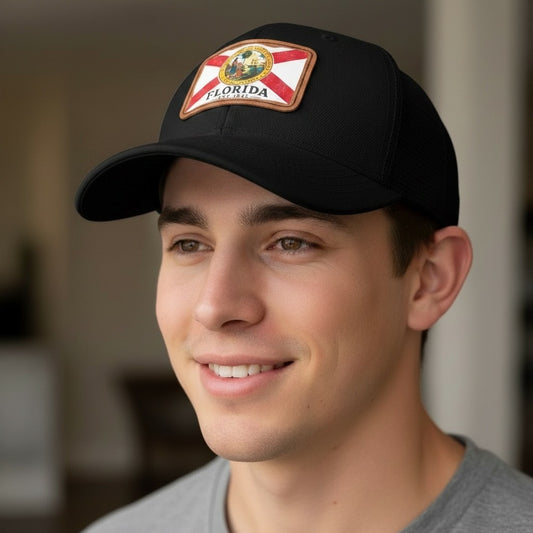 Man wearing a black cap with a Florida patch, smiling indoors.