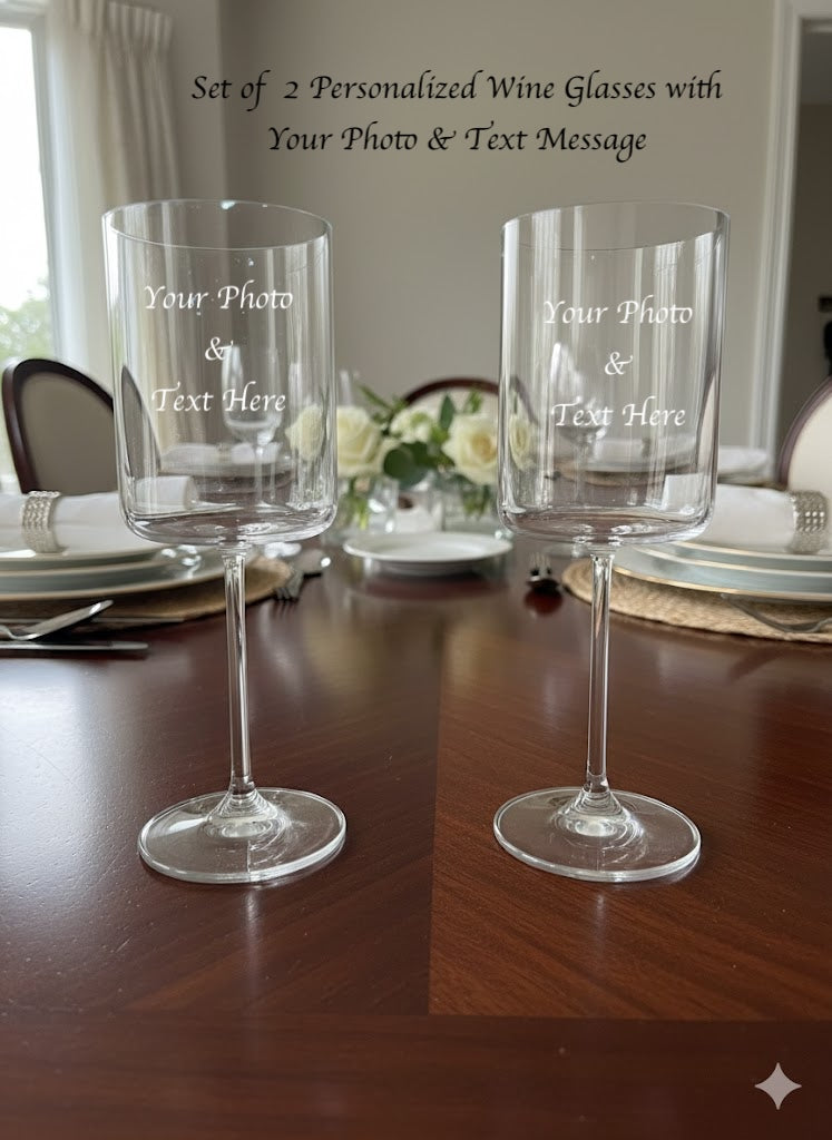 Two personalized wine glasses on a table with dinnerware