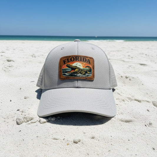 Gray cap with Florida patch on a sandy beach