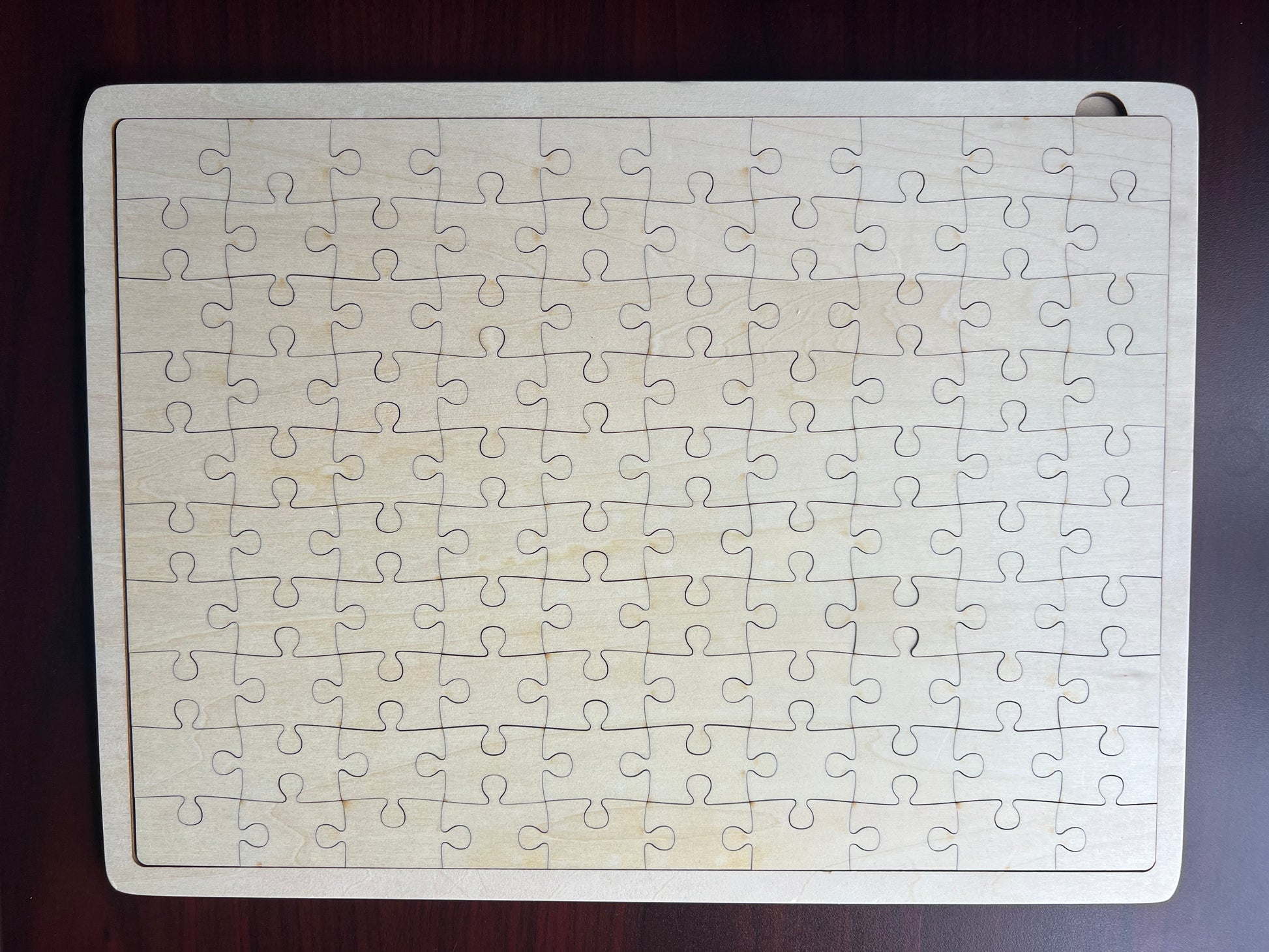 Jigsaw puzzle with all pieces on a wooden surface