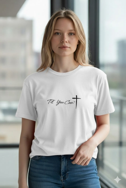Woman wearing a white t-shirt with text and a cross design in an indoor setting