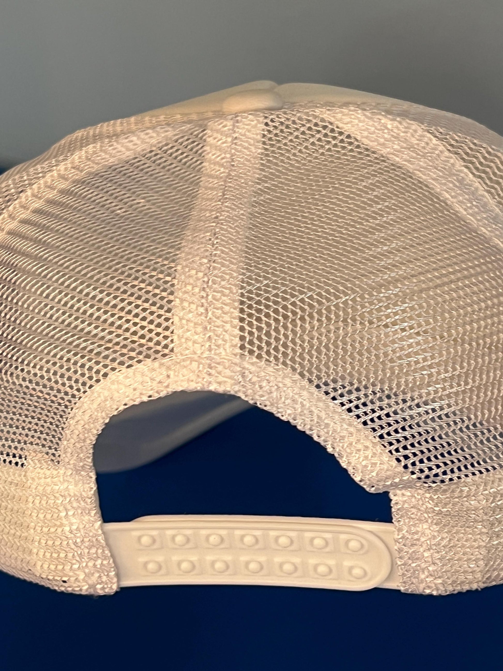 Beige mesh cap with a dark background