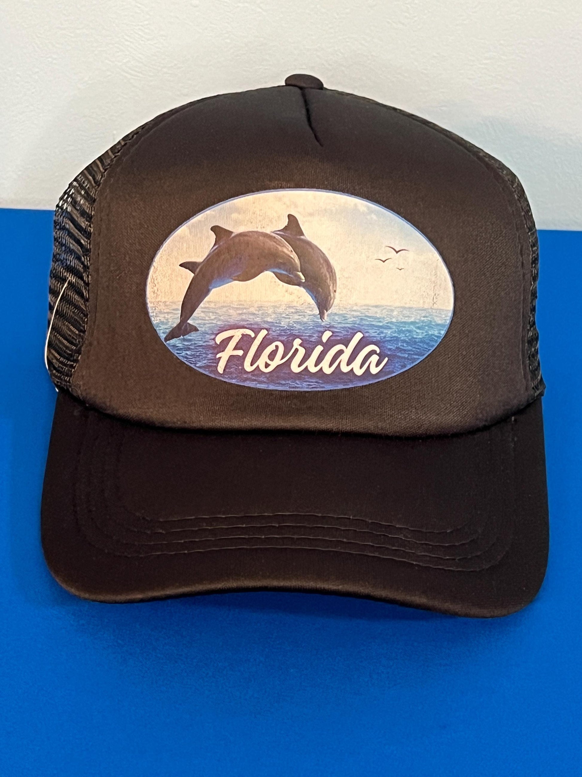 Black Trucker hat with dolphin design and 'Florida' text on a blue and white background