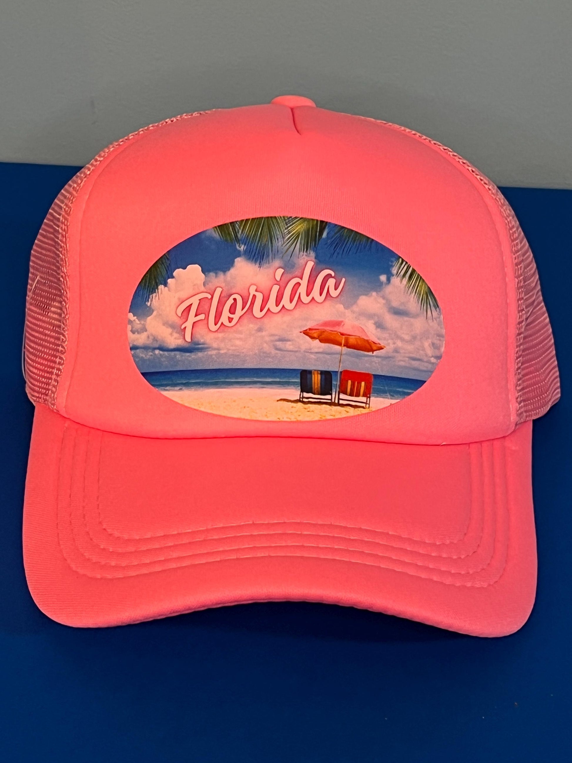 Pink trucker hat with a beach scene and 'Florida' text on a blue background