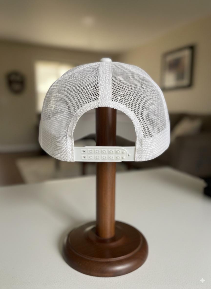 White mesh cap on a wooden stand with a blurred indoor background