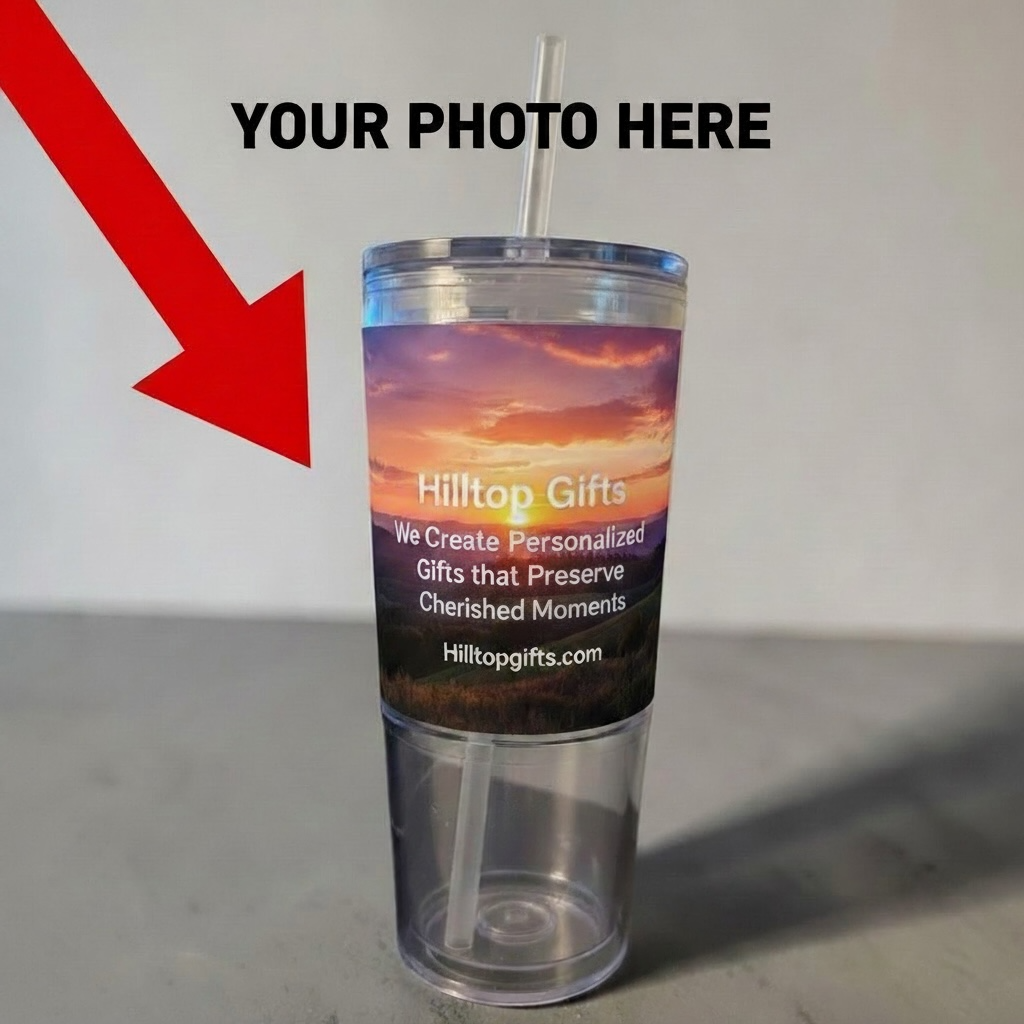 A clear plastic tumbler with a straw and a printed sunset wrap label reading Hilltop Gifts, shown on a gray surface against a light wall. Large text at the top says YOUR PHOTO HERE with a red arrow pointing to the cup, indicating a customizable photo area.