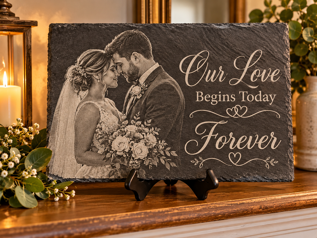 Wedding couple on a black slate with the words Our Love Begins Today Forever 