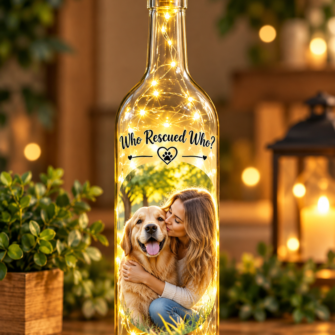 Clear decorative wine bottle with led lights inside and a women and her dog with the text who rescued who