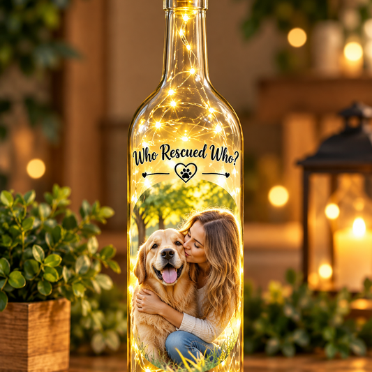 Clear decorative wine bottle with led lights inside and a women and her dog with the text who rescued who